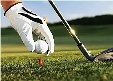 A person preparing for a golf shot on the golf course.